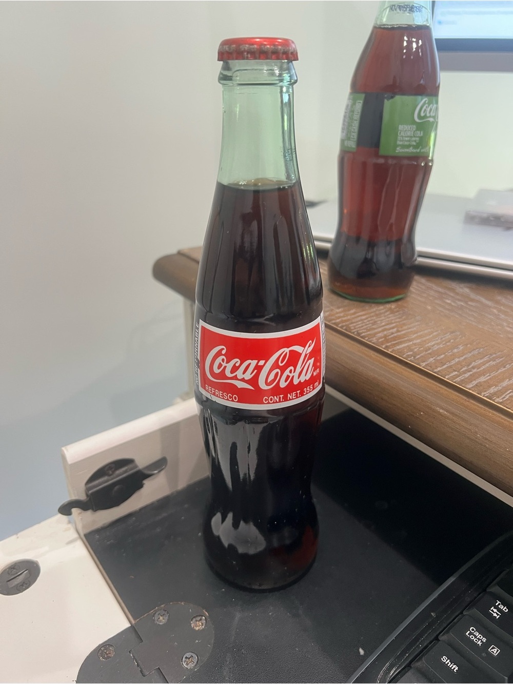 Coca-Cola bottle on desk